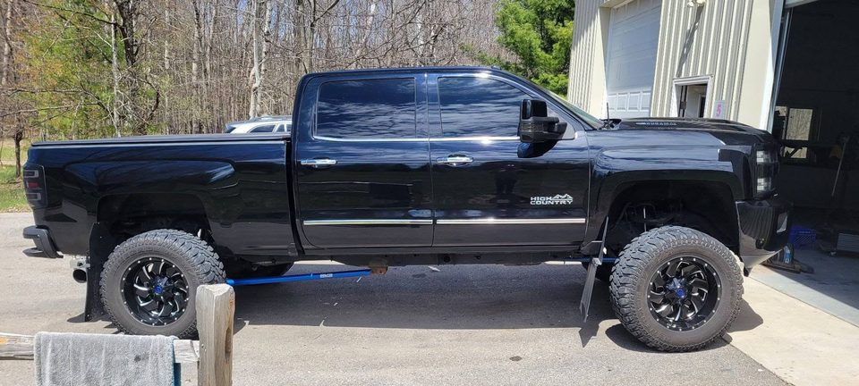 A repaired and refinished black pickup back on the road
