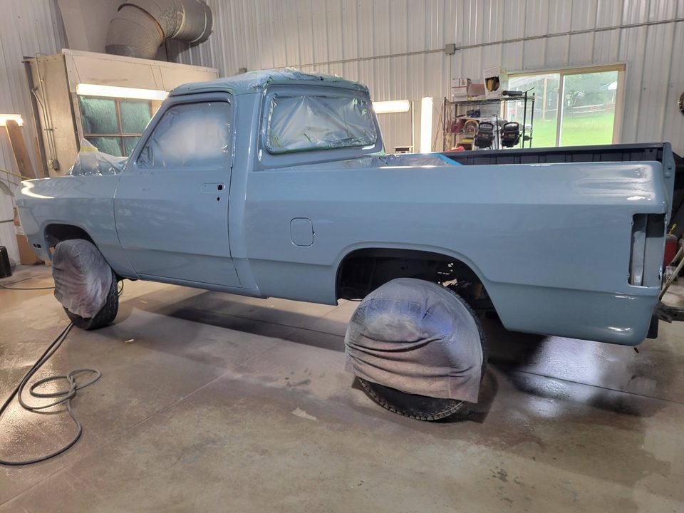 After — the same Dodge D150 in its fresh light blue finish