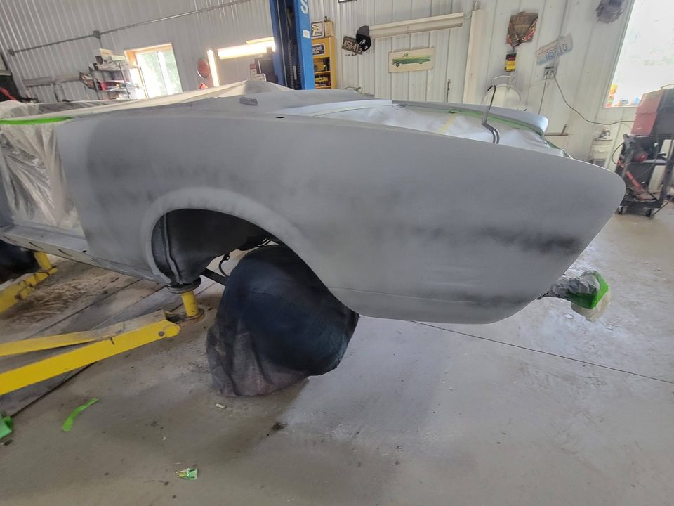 Stage 4 — body stripped and in primer on the lift