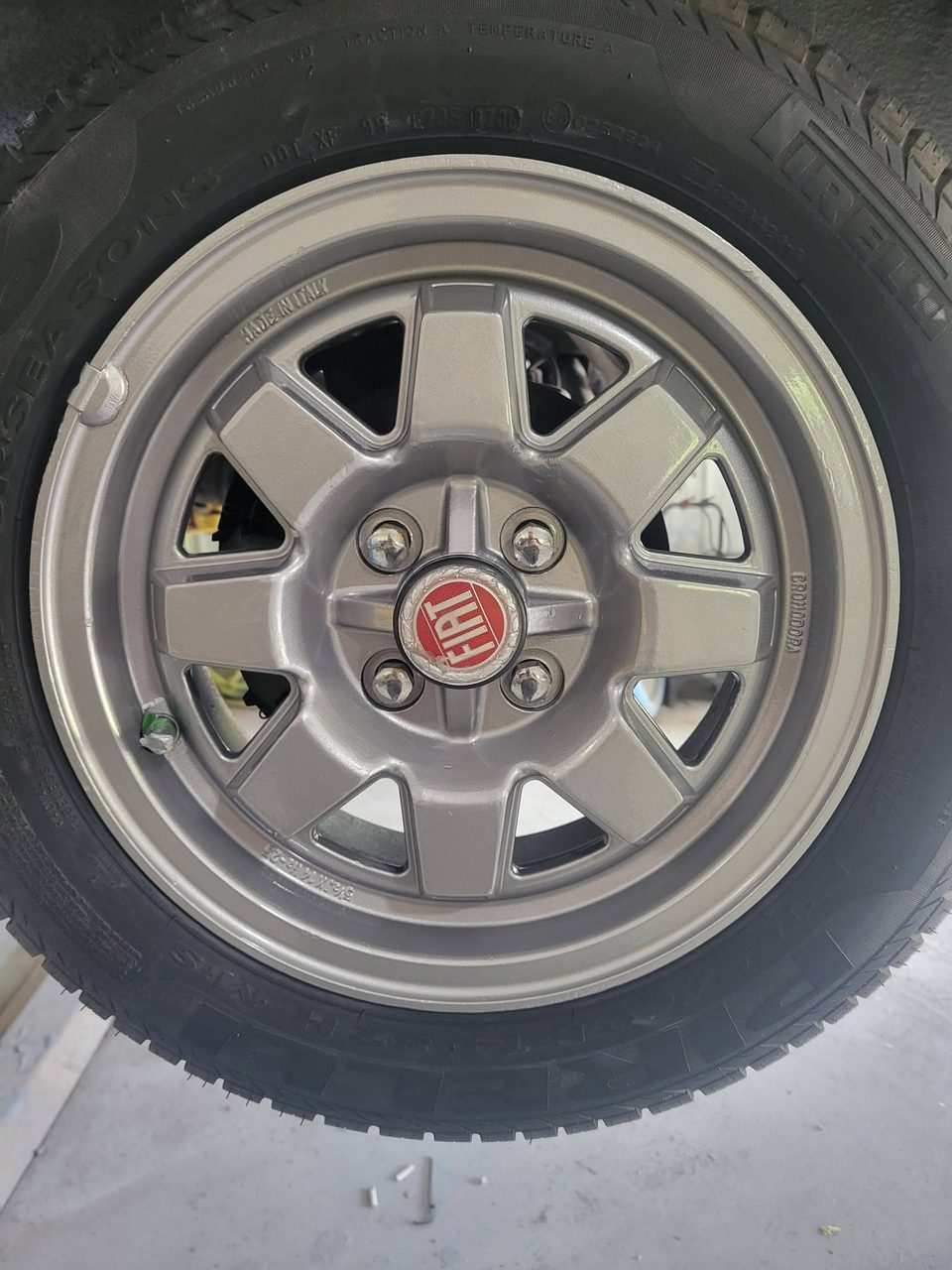 Stage 5 — fresh Fiat alloys wrapped for paint