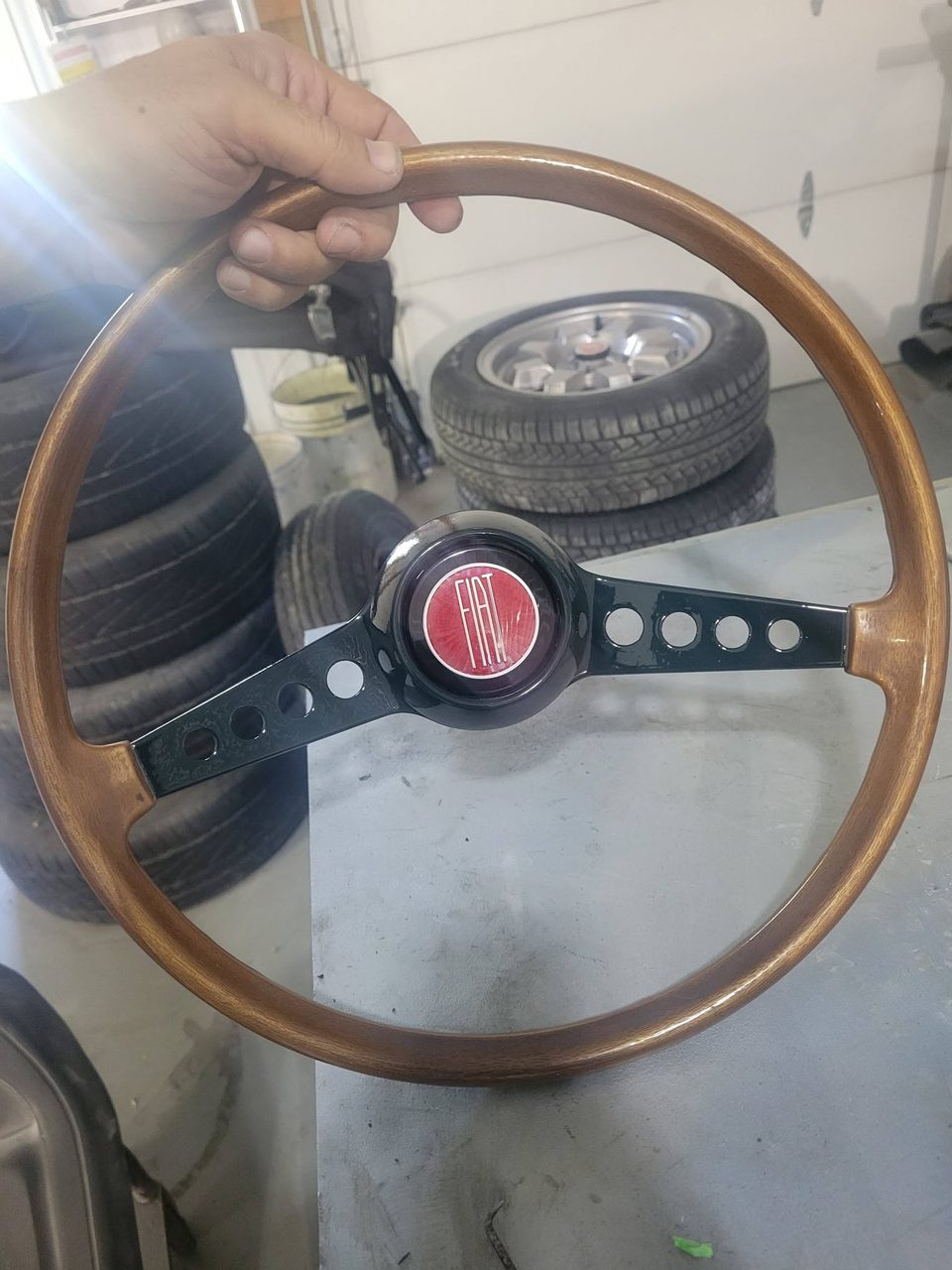 The wood-rim wheel with its Fiat horn button, ready to go back in