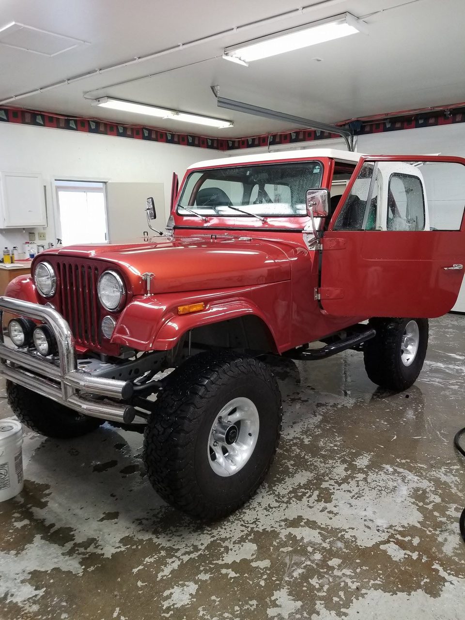 A restored red Jeep CJ-7 finished in the shop