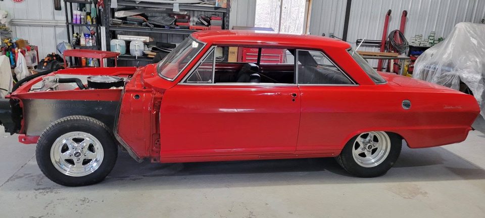 A classic Chevy II in the restoration bay during a long-term build