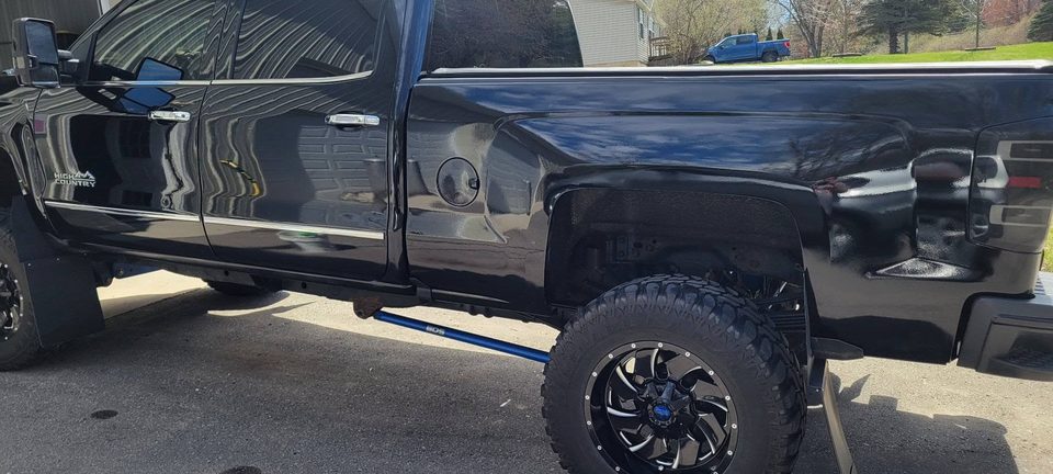Deep gloss and clean reflections down the side of a finished black pickup