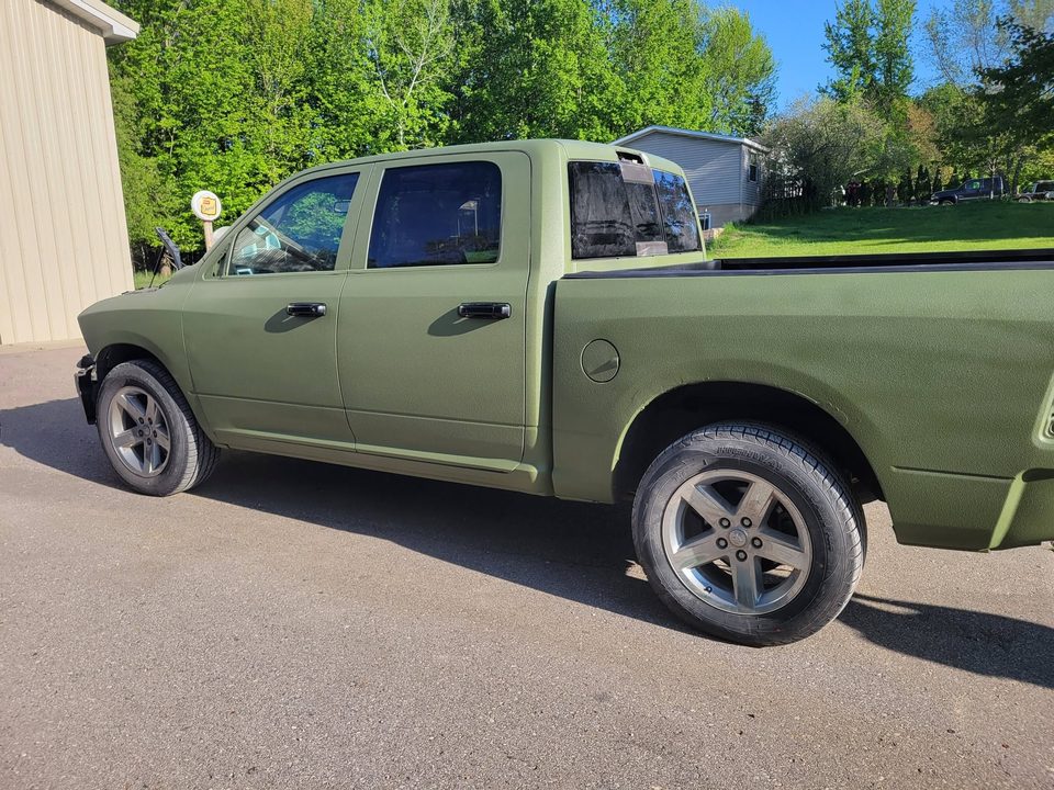 A finished olive green Ram 1500 after a full detail