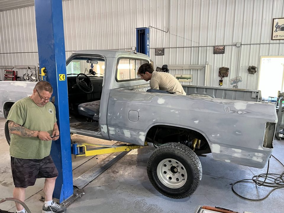Appearance Unlimited technicians working on a truck on the lift